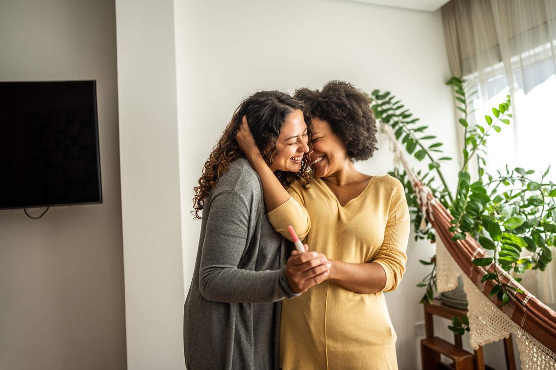 lesbian couple holding a pregnancy test